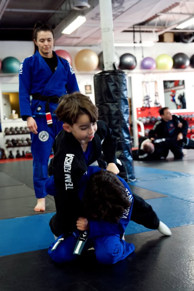 Coach leading a kids Brazilian Jiu-Jitsu class at Ippon Sports Academy